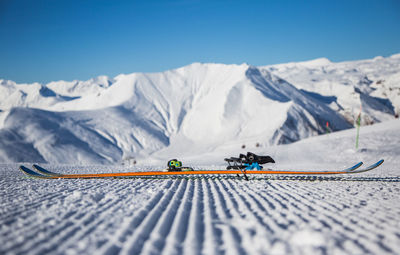 Snowboard against snowcapped mountains