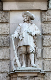 Low angle view of statue against wall