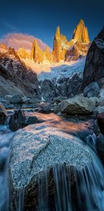 Scenic view of snowcapped mountains against sky during sunset