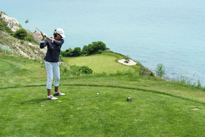 Full length of man standing on golf course