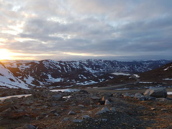 Scenic view of snowcapped mountains against sky during sunset