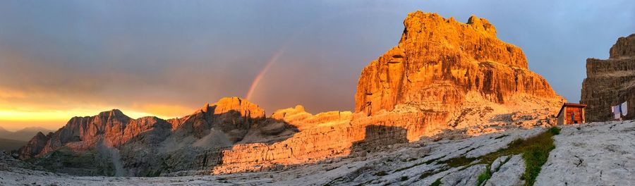 Panoramic view of rock formation against sky during sunset