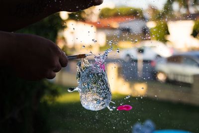 Close-up of hand holding bubbles in water