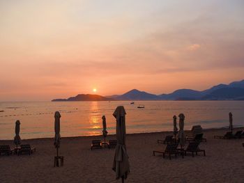 Scenic view of beach against sky during sunset