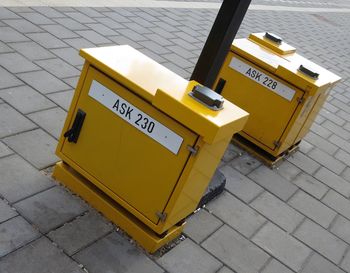 High angle view of yellow sign board