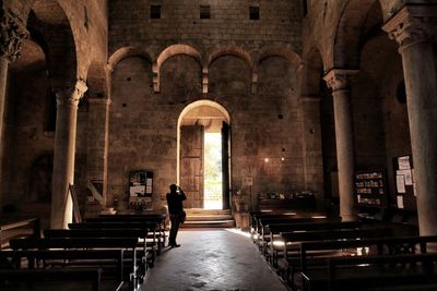 Man walking in corridor of historic building