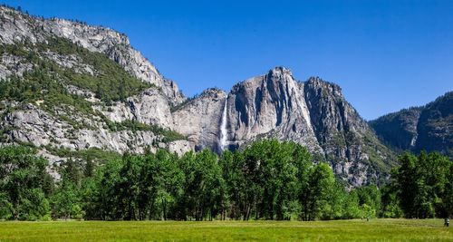 Scenic view of trees and mountains against clear sky