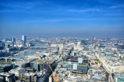 High angle view of modern buildings in city against sky