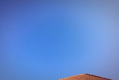 Low angle view of built structure against clear blue sky