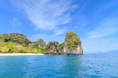 Long tail boat waiting for tourists at noppharat thara beach in andaman sea, krabi, thailand