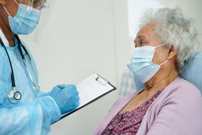 Doctor examining patient in hospital