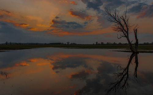 Scenic view of lake against romantic sky at sunset
