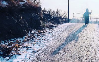 Rear view of person standing in winter