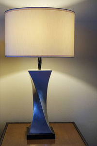 Close-up of illuminated lamp on table at home