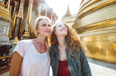 Happy women at temple in city