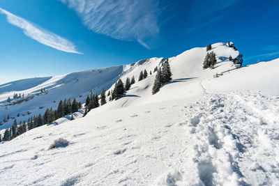 Snow covered mountains against blue sky