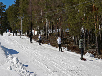 People walking on snow covered land