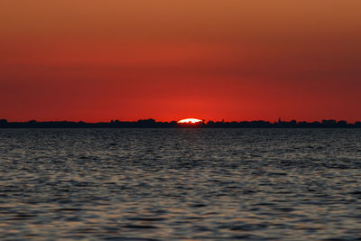 Scenic view of sea against romantic sky at sunset