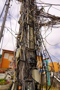 Low angle view of electricity pylon against sky