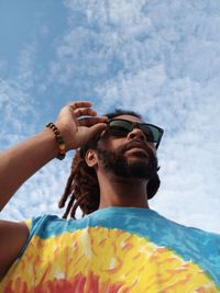 Low angle view of man wearing sunglasses against sky