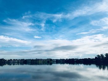 Scenic view of river against blue sky