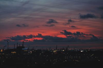 Silhouette city against sky at sunset