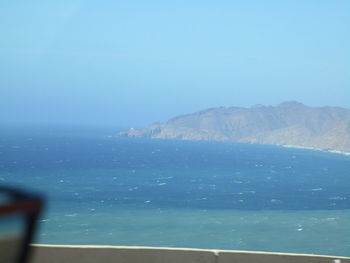 Scenic view of sea against clear blue sky