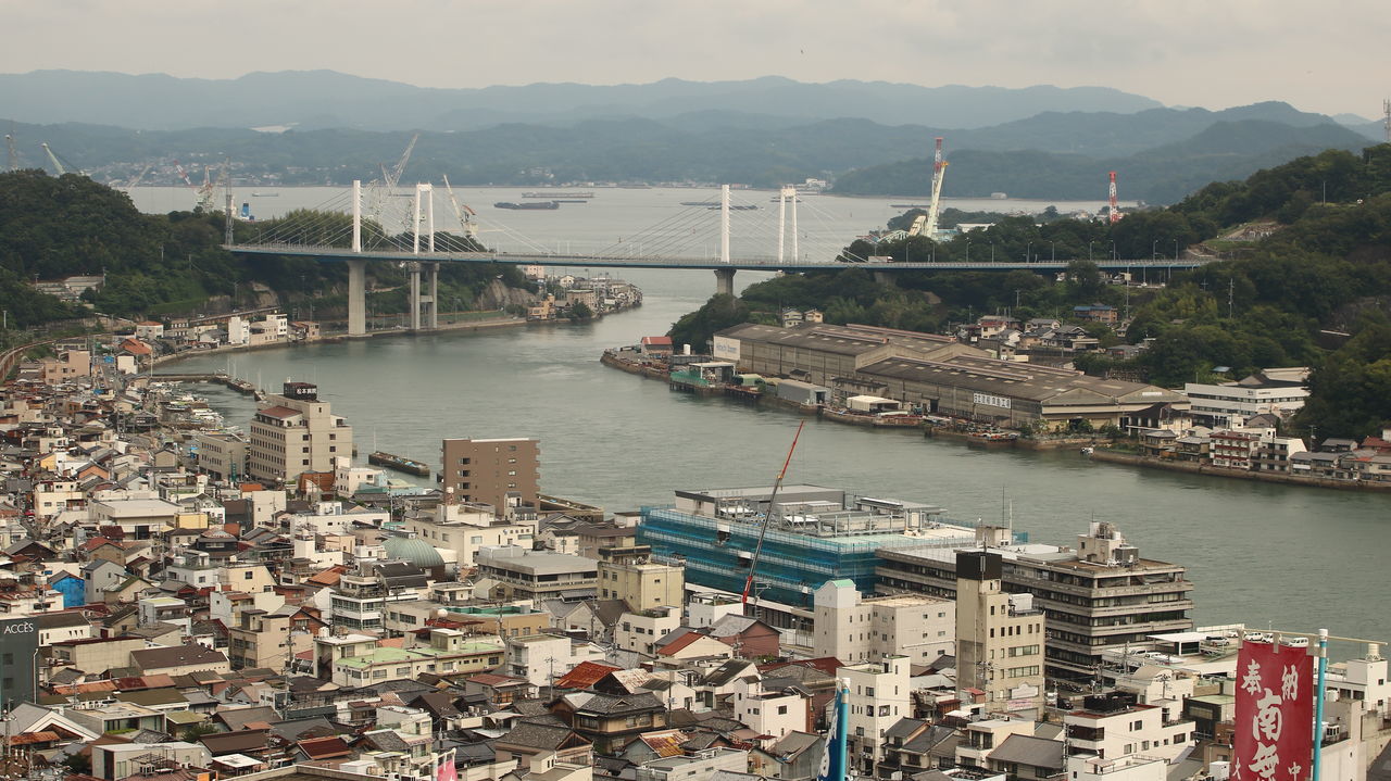 built structure, architecture, water, transportation, nautical vessel, building exterior, city, connection, bridge, nature, high angle view, river, bridge - man made structure, no people, mountain, day, mode of transportation, harbor, travel destinations, outdoors, bay, sailboat