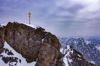 Low angle view of mountain against cloudy sky