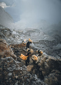 Man standing on rock against mountains