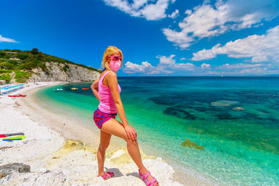 Woman on beach against sky