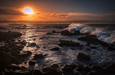 Scenic view of sea against dramatic sky