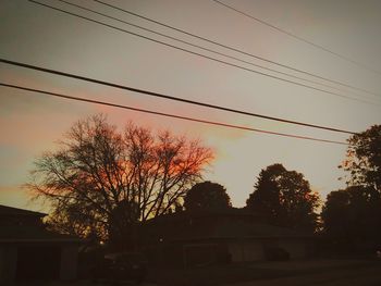 Low angle view of power lines against sky