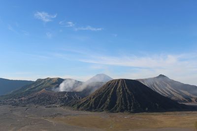 Scenic view of mountains against cloudy sky