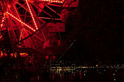 Low angle view of illuminated ferris wheel at night
