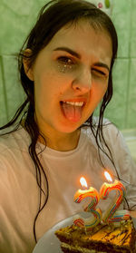 Close-up of girl blowing birthday cake