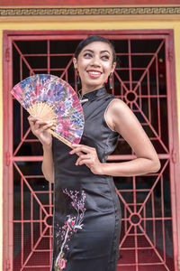 Portrait of young woman holding umbrella