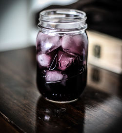 Close-up of ice cream in glass jar on table