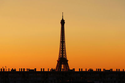 Silhouette eiffel tower against orange sky