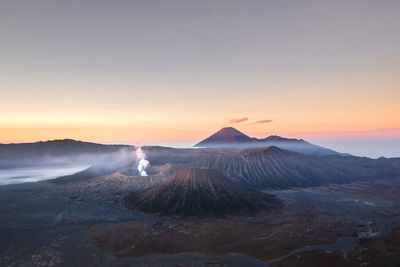 Volcanic landscape against sky during sunset