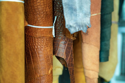 Close-up of leather hanging for sale at market