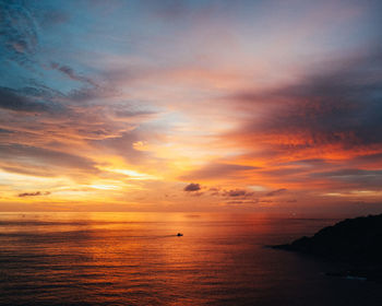 Scenic view of sea against orange sky