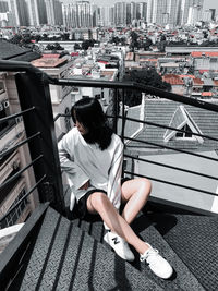 High angle view of woman sitting outdoors