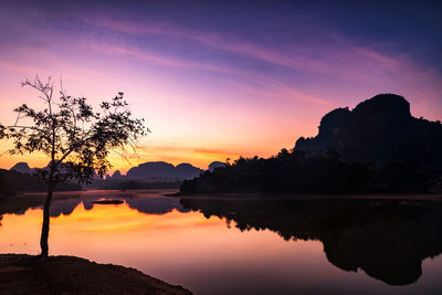 Scenic view of lake against romantic sky at dawn in nong thale