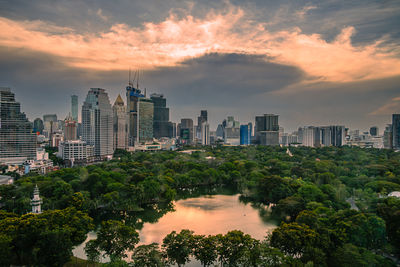 Buildings in city against sky during sunset