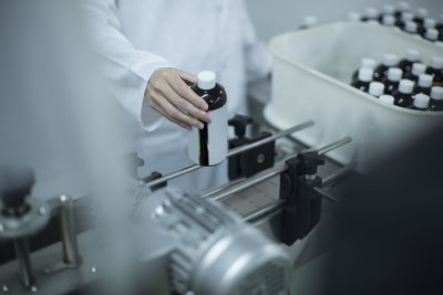 Worker with flask in medical factory