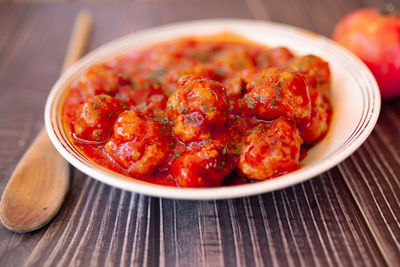 Closeup meatballs in sweet and sour tomato sauce. top view.