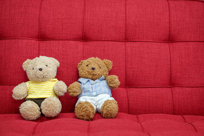 Close-up of stuffed toy against red background