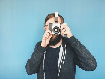 Man photographing against sky over white background