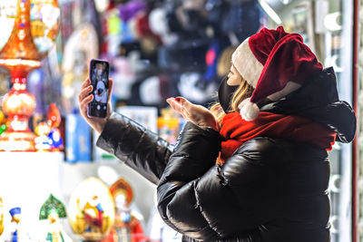 Rear view of man photographing